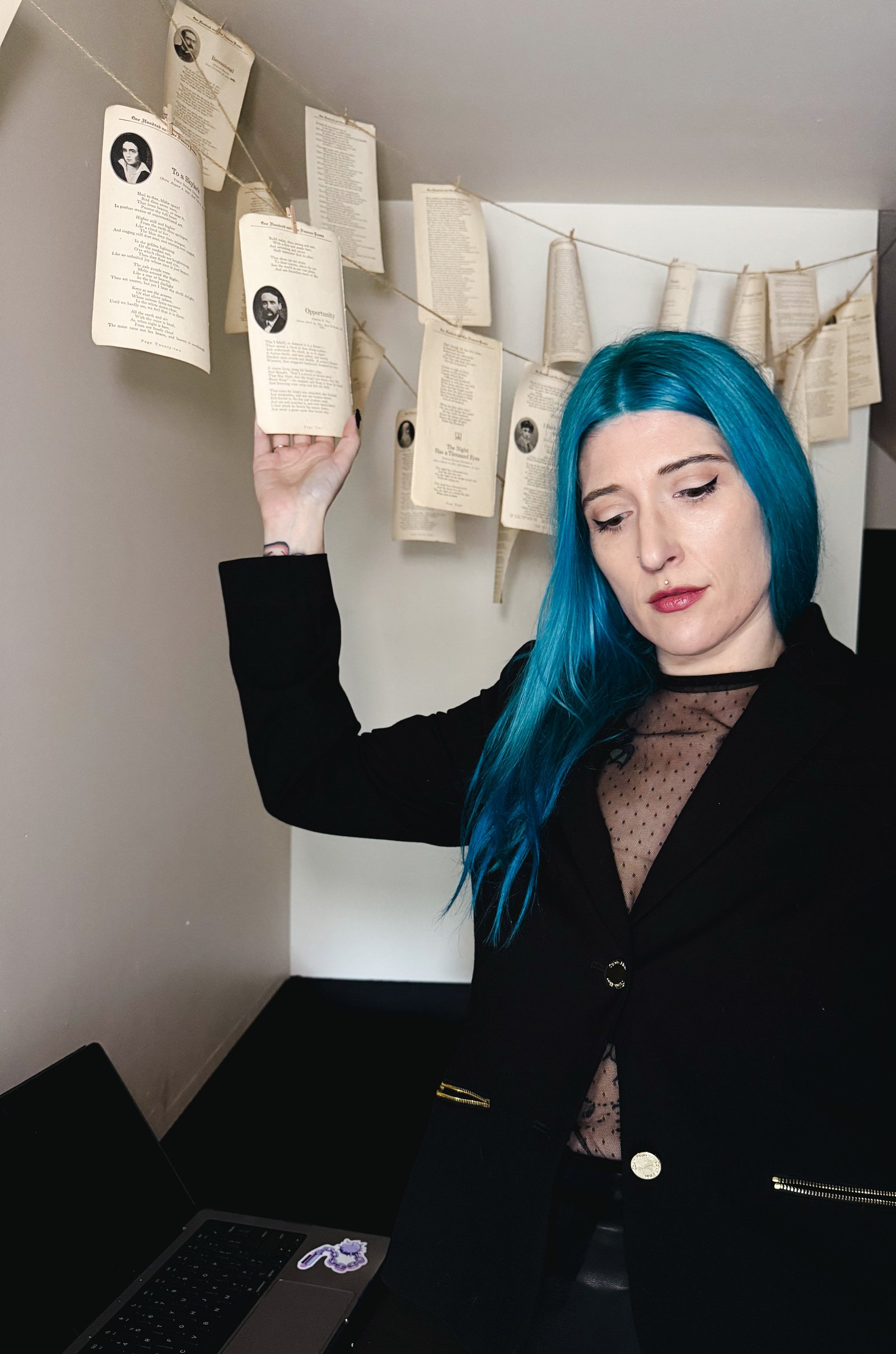 Amanda O’Green arranging a client journey wall with pinned cards and a laptop